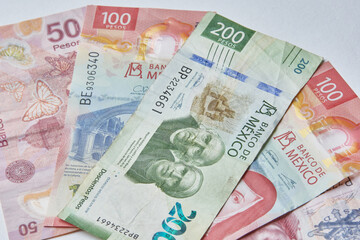 Obraz na płótnie Canvas Mexican money, Mexican pesos bills and coins on white background
