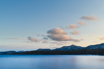 Long exposure sunset view of lake Kussharo from Wakoto Peninsula in winter, Hokkaido, Japan