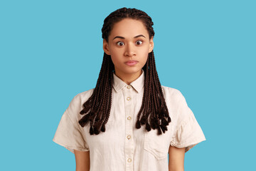 Portrait of funny silly woman with black dreadlocks looking at camera, cross eyed with stupid dumb...