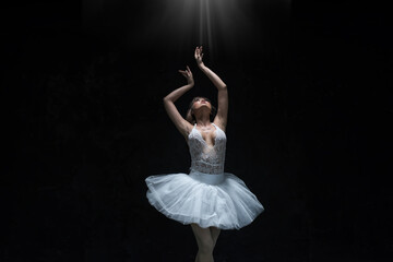 ballet dancer  on  floor . young ballerina with a perfect body is dancing in a photo studio, dancers are dressed in fashionable outfits, this picture is taken in minimal style, showing the beauty of c