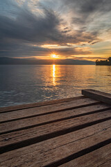 selective focus of wooden pier beach sunrise at Matano beach, south Sulawesi Indonesia