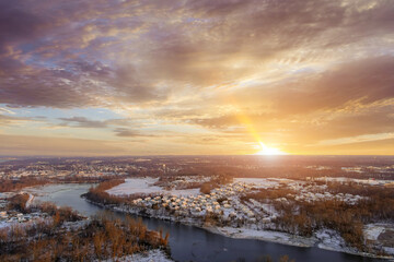 American small town at sunset after snowfall with an amazing aerial view of snow scenery in...