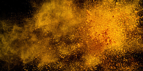 Fototapeta na wymiar Explosion, Splashes of turmeric on a black background. India Seasoning. The orange powder of the turmeric root. Explosion of powder