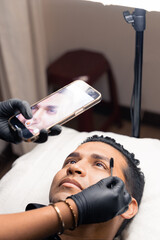 cosmetologist photographing the result of a micropigmentation treatment