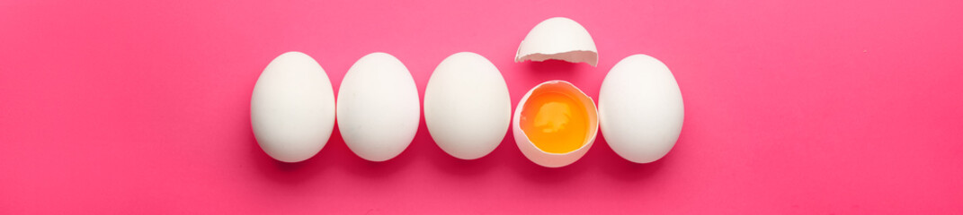 Cracked egg among whole ones on pink background. Concept of uniqueness