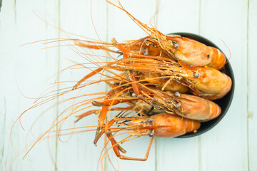 Boiled river shrimp its big on a black bowl