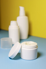 Fototapeta na wymiar mock up of white jar of cream on a yellow background. Ready place for the label, copy space