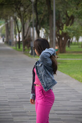 woman in the park with glasses and pink clothes