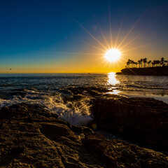 Sunset at Shaws Cove.  Wave Splashing on exposed rock.