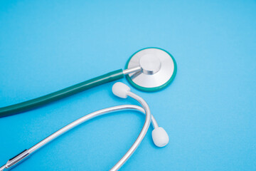 medical stethoscope on blue background with space for text