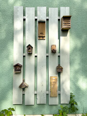 on a house wall hang various insect hotels