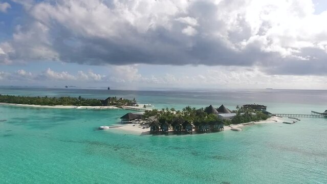 Drone shot of a Maldives island with dramatic clouds Full HD