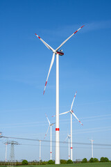 Wind turbines and power lines on a sunny day in Germany
