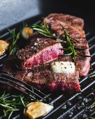 Tuinposter beef steak with rosemary, Rare, selective focus © CHZU