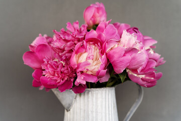 Beautiful bouquet of peonies in a jug
