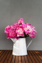Beautiful bouquet of pink peonies on a table. Wedding or birthday bouquet of pink peony flowers