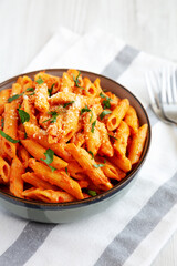 Homemade Penne Alla Vodka from Leftover Sauce with Cheese and Parsley, low angle view.