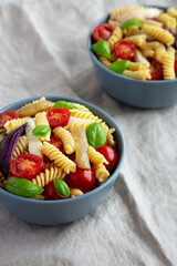 Homemade Fusilli Pasta Salad with Mozzarella and Vegetables, side view.