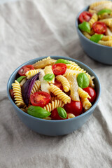 Homemade Fusilli Pasta Salad with Mozzarella and Vegetables, side view.