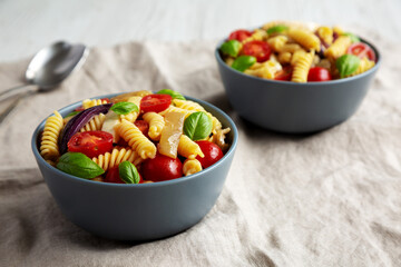 Homemade Fusilli Pasta Salad with Mozzarella and Vegetables, low angle view.