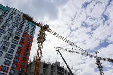 high tower crane. building a house. unfinished house. home construction equipment