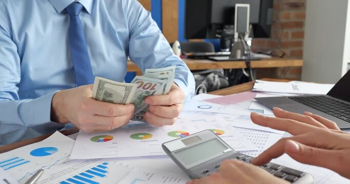 Business partners consider financial profit after transaction