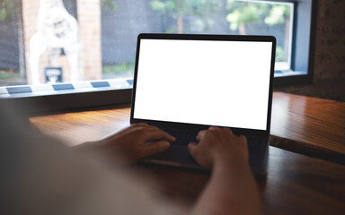 Mockup image of a woman working and typing on laptop with blank white desktop screen in office