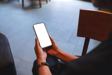 Mockup image of a woman holding mobile phone with blank desktop screen