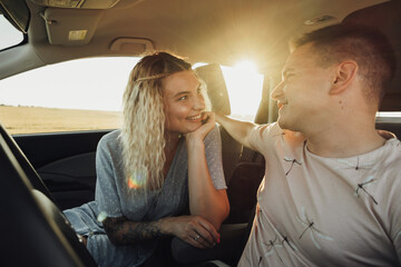 Happy Couple Enjoying Road Trip, Young Caucasian Woman and Man Having Fun Time While Traveling by Car