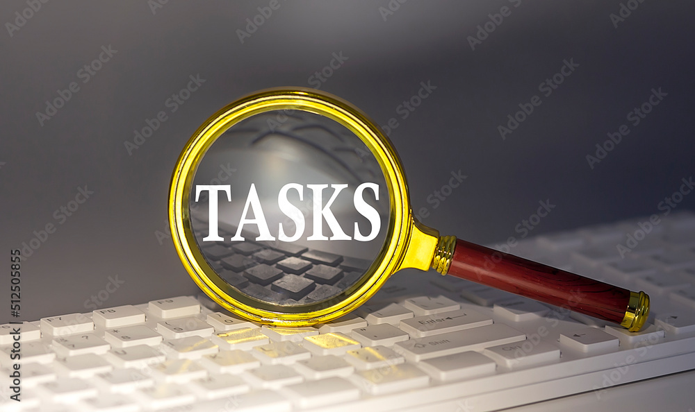 Poster tasks text on magnifier on a keyboard, business concept