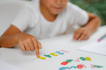 Preschooler Boy playing with numbers