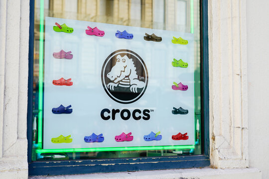 crocs text sign and logo brand front windows boutique American footwear company store manufactured foam clog plastic shoes shop