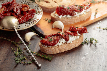 Bruschetta with ricotta, sun-dried tomatoes, and thyme.