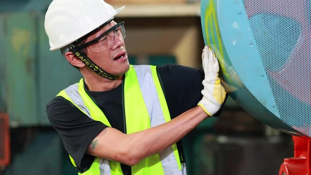 First Aid and safety first concept. Male factory worker arm stuck in machine.