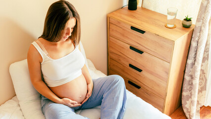 Pregnancy meditation yoga. Young pregnant mother meditating while sitting in lotus position. Health...