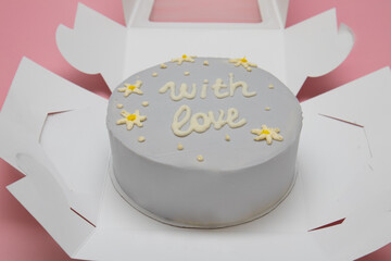 Cake. Bento. With the inscription "with love" in English. On a pink background. Copyspace High quality photo.