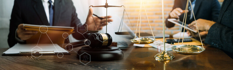 Business and lawyers discussing contract papers with brass scale on desk in office. Law, legal services, advice, justice and law concept picture with film grain effect