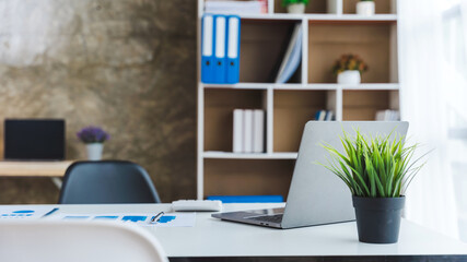 Office workplace with laptop and business object on wood table in the room.