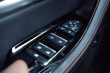 Car control panel auto button glass in a luxury car.automatic window lifter button on a modern car