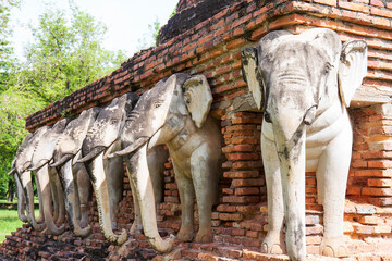 Fototapeta premium June 6, 2022, Sukhothai : Statue of elephants surrounded pagoda at Wat Sorasak,Temple in Sukhothai Historical Park, Sukhothai province,Thailand.