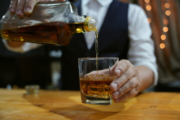 Barman pouring whiskey whiskey glass beautiful night