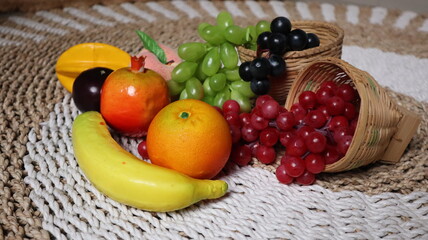 Basket bamboo and fresh fruits on the carpet made of grass. High quality photos