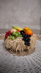 Basket bamboo and fresh fruits on the carpet made of grass. High quality photos