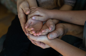 hands of grandfather and granddaughter with prayer