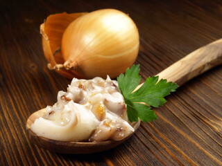 Pork Lard - Rendered Pig Fat on a Spoon on wooden Background