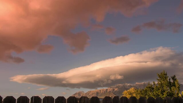 Time lapse of lenticular clouds rolling in the sky during sunset from backyard.