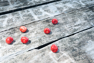 Red cherries on a wooden background.