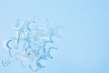 set of several Retractor Dental lip retractor Access to the oral cavity. Wide mouth opening for a dental procedure on a clean blue background