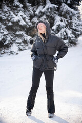 beautiful blonde woman in pink hat relaxing in winter snow forest