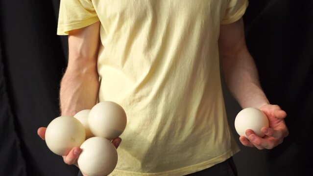 juggler with balls, throw balls from hand to hand, guy juggles, professional circus artist